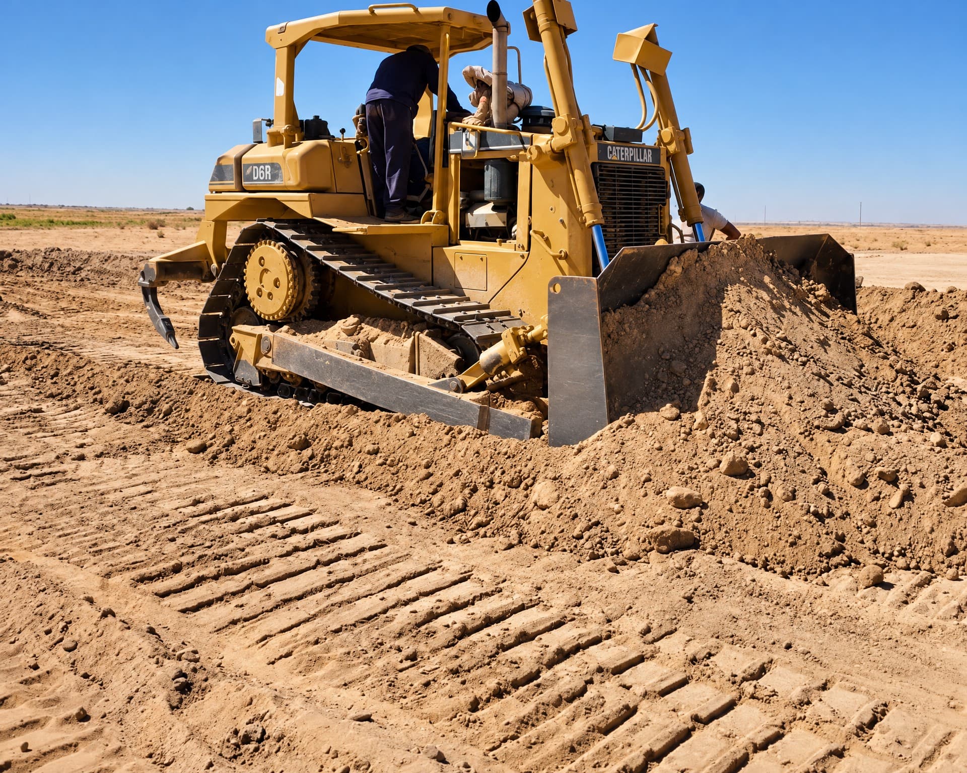 CAT D6R bulldozer pushing soil during earthmoving.